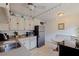 Cozy kitchen featuring white cabinets, stainless steel appliances, and a breakfast nook at 6700 Sunset Way # 303, St Pete Beach, FL 33706