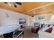 Living room with ceiling fan, TV, nautical decorations, and comfortable seating at 6700 Sunset Way # 303, St Pete Beach, FL 33706