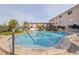 Beautiful community pool with ample lounge seating and tropical landscaping at 6700 Sunset Way # 303, St Pete Beach, FL 33706