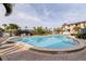 Community pool with brick pavers and surrounding palm trees offers a refreshing outdoor oasis at 6700 Sunset Way # 303, St Pete Beach, FL 33706