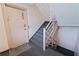 Condo stairway featuring gray carpeted steps, wooden railings, and unit door at 6700 Sunset Way # 303, St Pete Beach, FL 33706