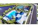 A stunning aerial view of a community pool, tennis and basketball courts, and playground near the lake at 6807 162Nd Pl, Parrish, FL 34219