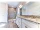 Bathroom featuring double sinks with granite counters and a tiled shower at 6807 162Nd Pl, Parrish, FL 34219