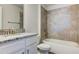 Bathroom with a granite countertop vanity, a tiled shower-over-tub, and modern fixtures at 6807 162Nd Pl, Parrish, FL 34219
