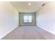 Neutral carpeted room with a bright window overlooking a serene pond at 6807 162Nd Pl, Parrish, FL 34219