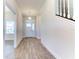 Bright foyer features wood-look tile flooring, a pendant light fixture, and stairs to the second level at 6807 162Nd Pl, Parrish, FL 34219