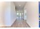 Bright hallway featuring wood-look tile flooring leading to a spacious living area with backyard views at 6807 162Nd Pl, Parrish, FL 34219