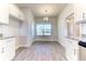 Eat-in kitchen includes white cabinets, granite countertops, stainless appliances, and a large window at 6807 162Nd Pl, Parrish, FL 34219