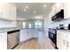 The modern kitchen features white cabinets, stainless steel appliances, granite countertops and a large sink at 6807 162Nd Pl, Parrish, FL 34219