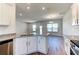 Kitchen with granite countertops, stainless appliances, white cabinets, and view into the living room at 6807 162Nd Pl, Parrish, FL 34219
