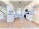 Bright, open kitchen with granite counters, stainless steel appliances, and wood-look tile flooring at 6807 162Nd Pl, Parrish, FL 34219