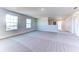 Spacious living room with neutral carpet, white walls, and plenty of natural light from the two large windows at 6807 162Nd Pl, Parrish, FL 34219