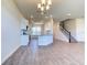 Bright, open-concept room featuring modern tile flooring, kitchen, and staircase at 6807 162Nd Pl, Parrish, FL 34219