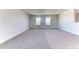 Large carpeted loft area with abundant natural light from two windows at 6807 162Nd Pl, Parrish, FL 34219