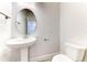 This powder room features a pedestal sink, oval mirror, toilet, and tile flooring at 6807 162Nd Pl, Parrish, FL 34219
