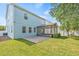 Spacious backyard features covered patio, lush lawn, privacy fence, and mature trees at 7710 S Desoto St, Tampa, FL 33616