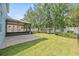 Well-maintained backyard featuring a patio, lawn, and tropical landscaping, great for entertaining at 7710 S Desoto St, Tampa, FL 33616