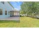 Expansive backyard featuring a patio, green lawn, and privacy fence, offering a serene outdoor space at 7710 S Desoto St, Tampa, FL 33616