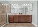 Bathroom featuring a glass door shower, double vanity sink with great lighting, and soft, soothing colors at 7710 S Desoto St, Tampa, FL 33616
