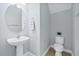 Half bathroom with white pedestal sink and toilet at 7710 S Desoto St, Tampa, FL 33616