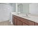 Bathroom showcasing a vanity with double sinks, a well-lit mirror, and a shower-tub combo at 7710 S Desoto St, Tampa, FL 33616