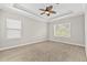 Inviting bedroom with carpet, ceiling fan, and natural light from two windows at 7710 S Desoto St, Tampa, FL 33616
