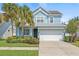 Charming two-story home with a well-manicured lawn and a two-car garage at 7710 S Desoto St, Tampa, FL 33616