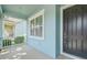 Inviting front entry with a dark-colored door and manicured landscaping at 7710 S Desoto St, Tampa, FL 33616