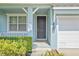 Inviting front entry with a dark-colored door and manicured landscaping at 7710 S Desoto St, Tampa, FL 33616