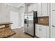 Spacious kitchen with stainless steel refrigerator and granite countertops at 7710 S Desoto St, Tampa, FL 33616