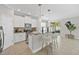Modern kitchen with white cabinets, granite countertops, and an island with seating at 7710 S Desoto St, Tampa, FL 33616