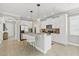 A bright, modern kitchen with a kitchen island, stainless steel appliances, and plenty of storage at 7710 S Desoto St, Tampa, FL 33616
