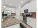 This kitchen has granite countertops, stainless steel appliances, and a tiled backsplash at 7710 S Desoto St, Tampa, FL 33616