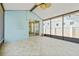 Enclosed lanai features tile flooring, ceiling fan, access to yard, and serene views of fenced backyard at 7710 S Desoto St, Tampa, FL 33616