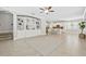 Open-concept living room flows into a kitchen with bright light and neutral tones at 7710 S Desoto St, Tampa, FL 33616