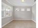 Open living area with neutral walls, tile floors, and natural light at 7710 S Desoto St, Tampa, FL 33616