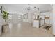 Spacious living room featuring tile floors, built-in shelving, and an open layout to the kitchen at 7710 S Desoto St, Tampa, FL 33616