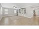 Bright living room boasts tile flooring, large windows, and custom built-in shelving at 7710 S Desoto St, Tampa, FL 33616