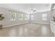 Bright living room features tile floors, large windows, custom built-in shelving, and neutral paint at 7710 S Desoto St, Tampa, FL 33616