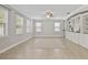Bright living room features tile floors, large windows providing natural light, and custom built-in shelving at 7710 S Desoto St, Tampa, FL 33616