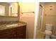 Bathroom featuring a granite vanity, toilet, and enclosed shower area at 8011 Peach Dr # 103, Tampa, FL 33637