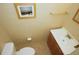 Clean bathroom featuring a vanity, towel rack, framed artwork, and white porcelain toilet at 8011 Peach Dr # 103, Tampa, FL 33637