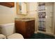 Bathroom featuring a granite vanity, shower with patterned curtain, and white porcelain toilet at 8011 Peach Dr # 103, Tampa, FL 33637