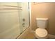 Bathroom featuring a bathtub with sliding glass doors and a toilet at 8011 Peach Dr # 103, Tampa, FL 33637
