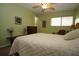 Bedroom boasting a window, ceiling fan, and artwork on the walls at 8011 Peach Dr # 103, Tampa, FL 33637