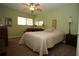 Comfortable bedroom with a ceiling fan, window, mirror, and neutral-toned walls at 8011 Peach Dr # 103, Tampa, FL 33637