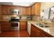 Updated kitchen featuring wood cabinets, stone countertops, and stainless steel appliances at 8011 Peach Dr # 103, Tampa, FL 33637