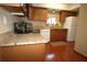 Well-lit kitchen featuring wood cabinets, stone countertops, and stainless steel appliances at 8011 Peach Dr # 103, Tampa, FL 33637