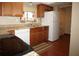 Bright kitchen featuring wood cabinets, stone countertops, stainless appliances, and a cozy breakfast nook at 8011 Peach Dr # 103, Tampa, FL 33637