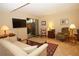 Cozy living room area with tile flooring, neutral walls, and access to outdoor space through sliding glass doors at 8011 Peach Dr # 103, Tampa, FL 33637